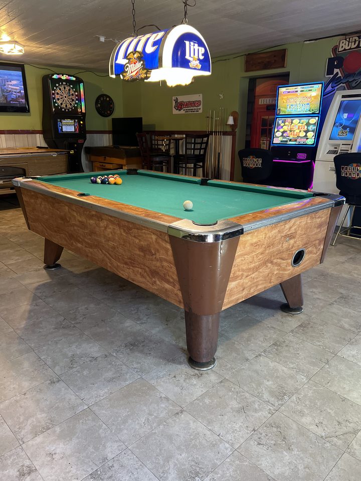 Pool table under a hanging lamp at The Root Cellar, Black Creek, WI